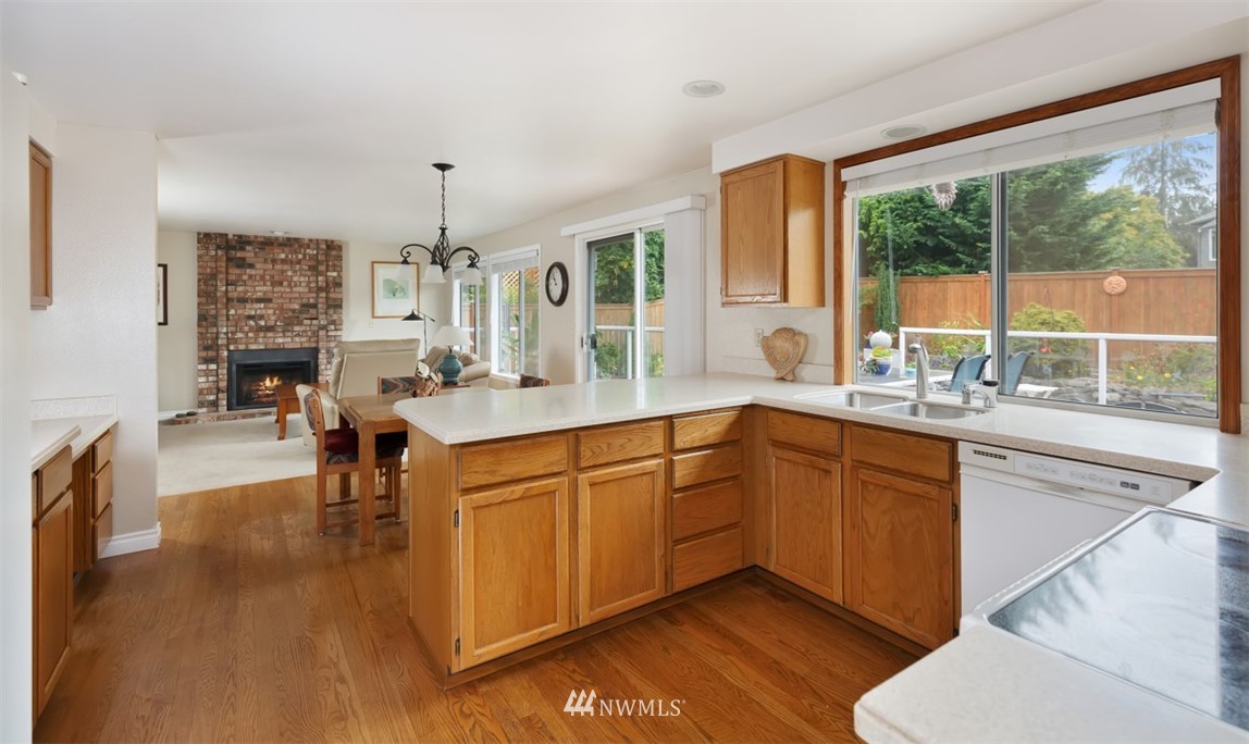 15720 Southeast 184th Street Renton, WA 98058 - Photo 17 of 30 a kitchen with stainless steel appliances granite countertop sink stove and wooden cabinets