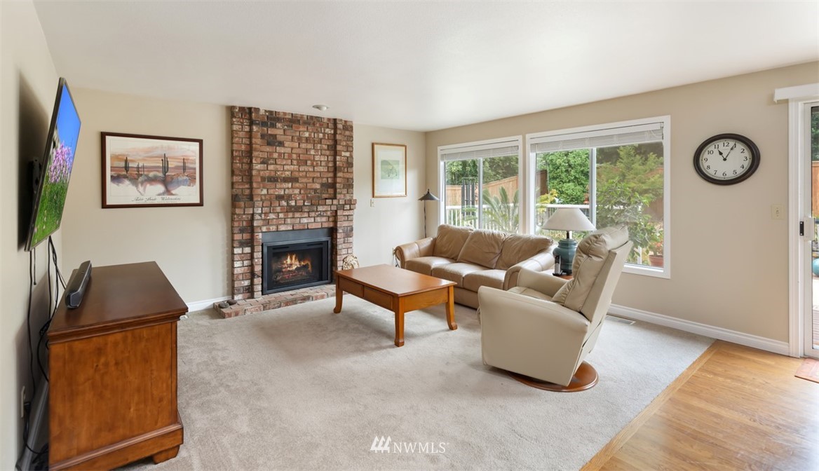 15720 Southeast 184th Street Renton, WA 98058 - Photo 20 of 30 a living room with furniture and a fireplace