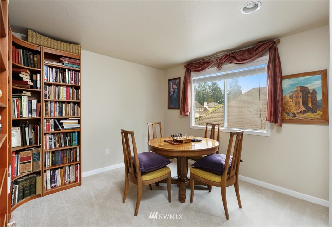 15720 Southeast 184th Street Renton, WA 98058 - Photo 30 of 30 a view of a dining room with furniture and a book shelf