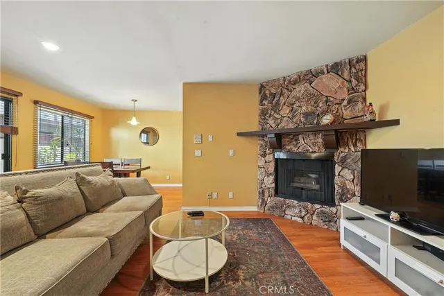 a living room with furniture a window and wooden floor