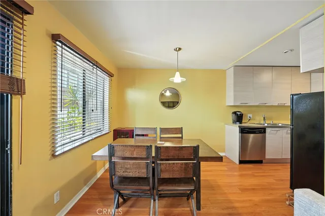 a large kitchen with stainless steel appliances granite countertop a refrigerator and a stove top oven