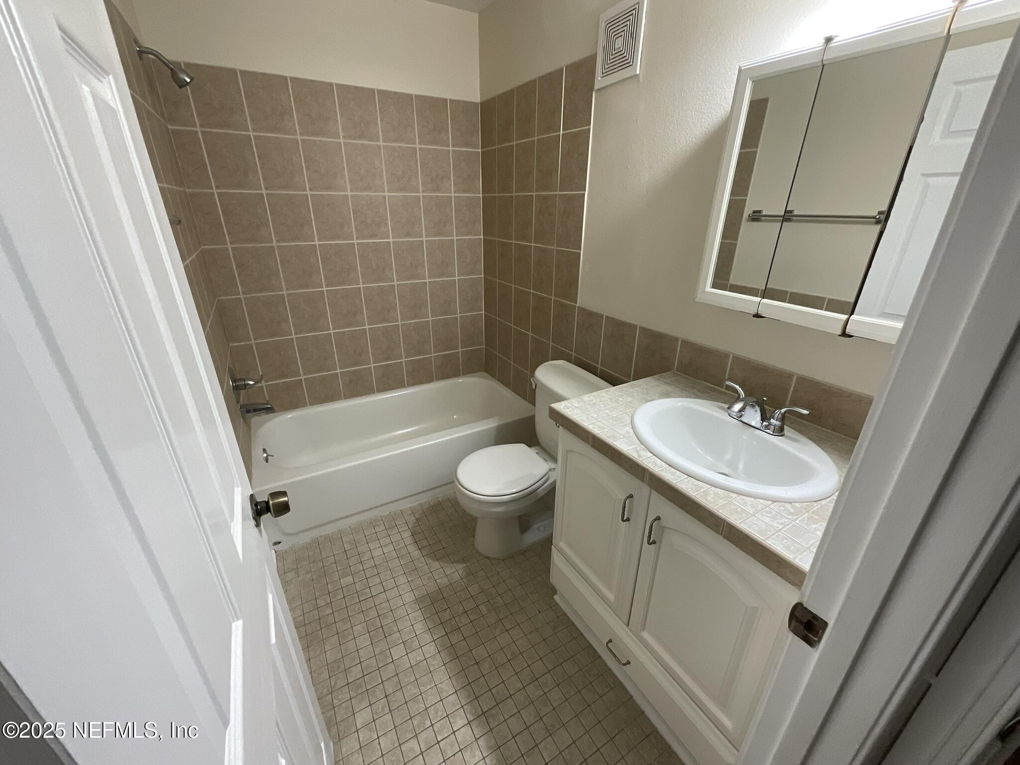 650 West Pope Road, Unit 252 St. Augustine, FL 32080 - Photo 4 of 33 a bathroom with a sink a toilet a mirror and shower