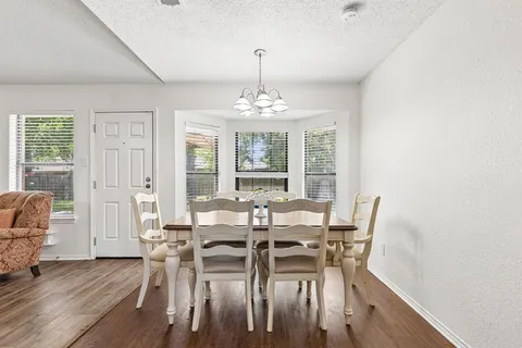 a living room with furniture a flat screen tv and kitchen view