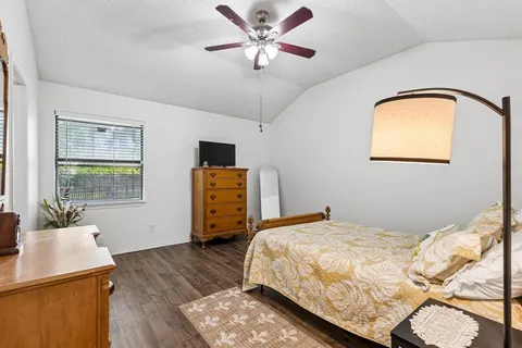 a bedroom with a bed and wooden floor