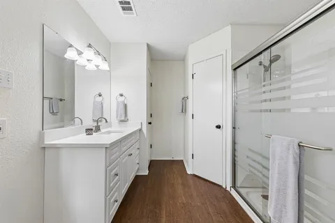 a bathroom with a sink a toilet and shower