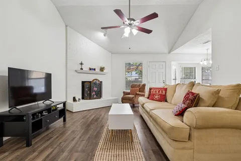 a living room with furniture a rug and a chandelier