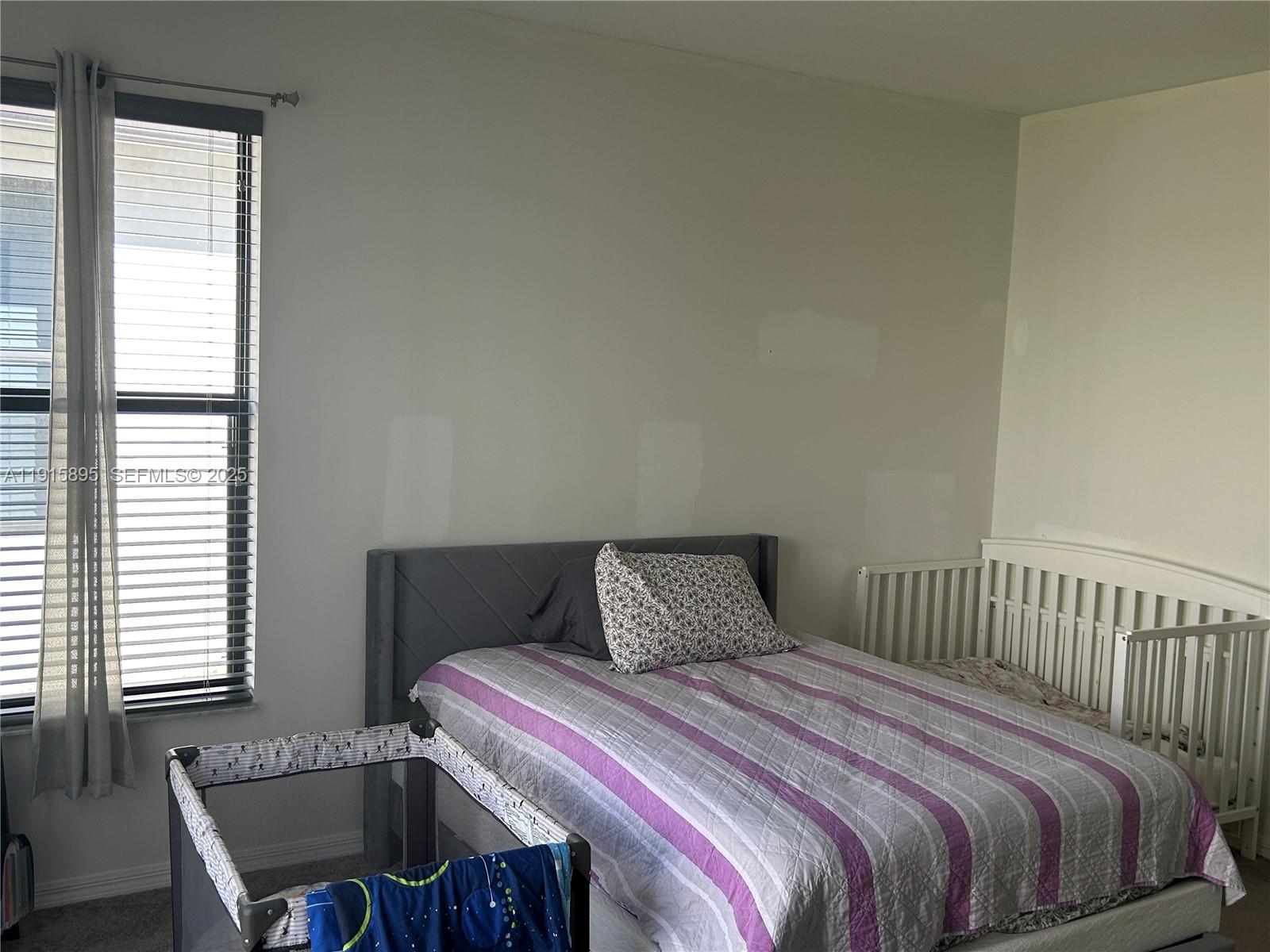 5518 Useppa Drive Immokalee, FL 34142 - Photo 6 of 14 a bedroom with a bed and window