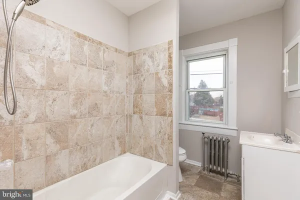 a bathroom with a bathtub and window