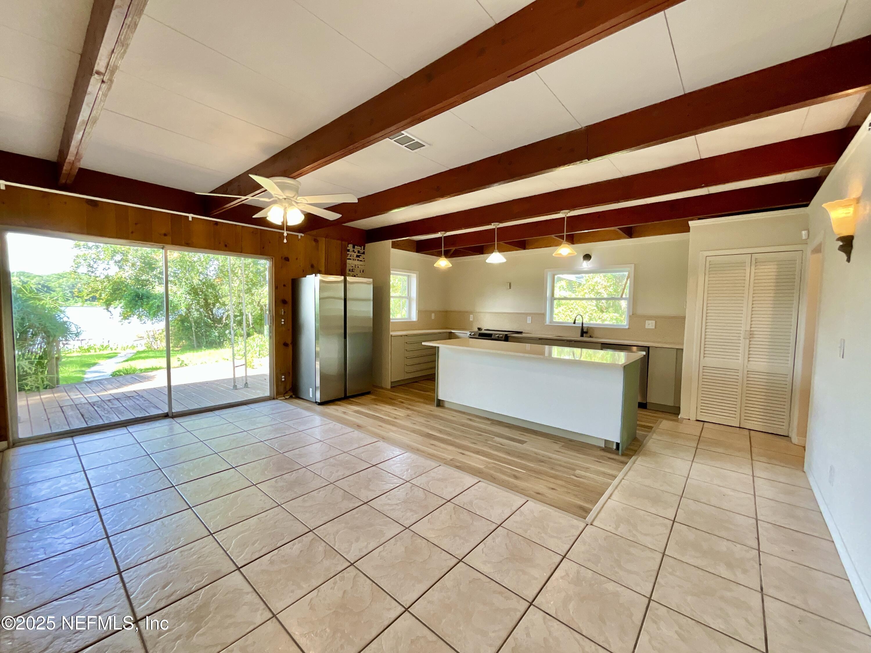 145 Depot Road Hawthorne, FL 32640 - Photo 20 of 73 a view of empty room with wooden floor and fan