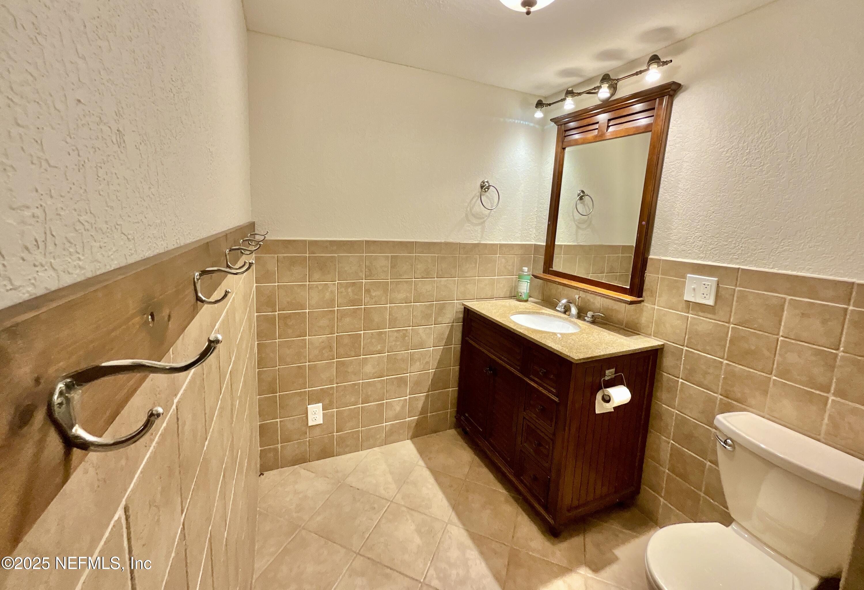 145 Depot Road Hawthorne, FL 32640 - Photo 30 of 73 a bathroom with a sink vanity mirror and toilet