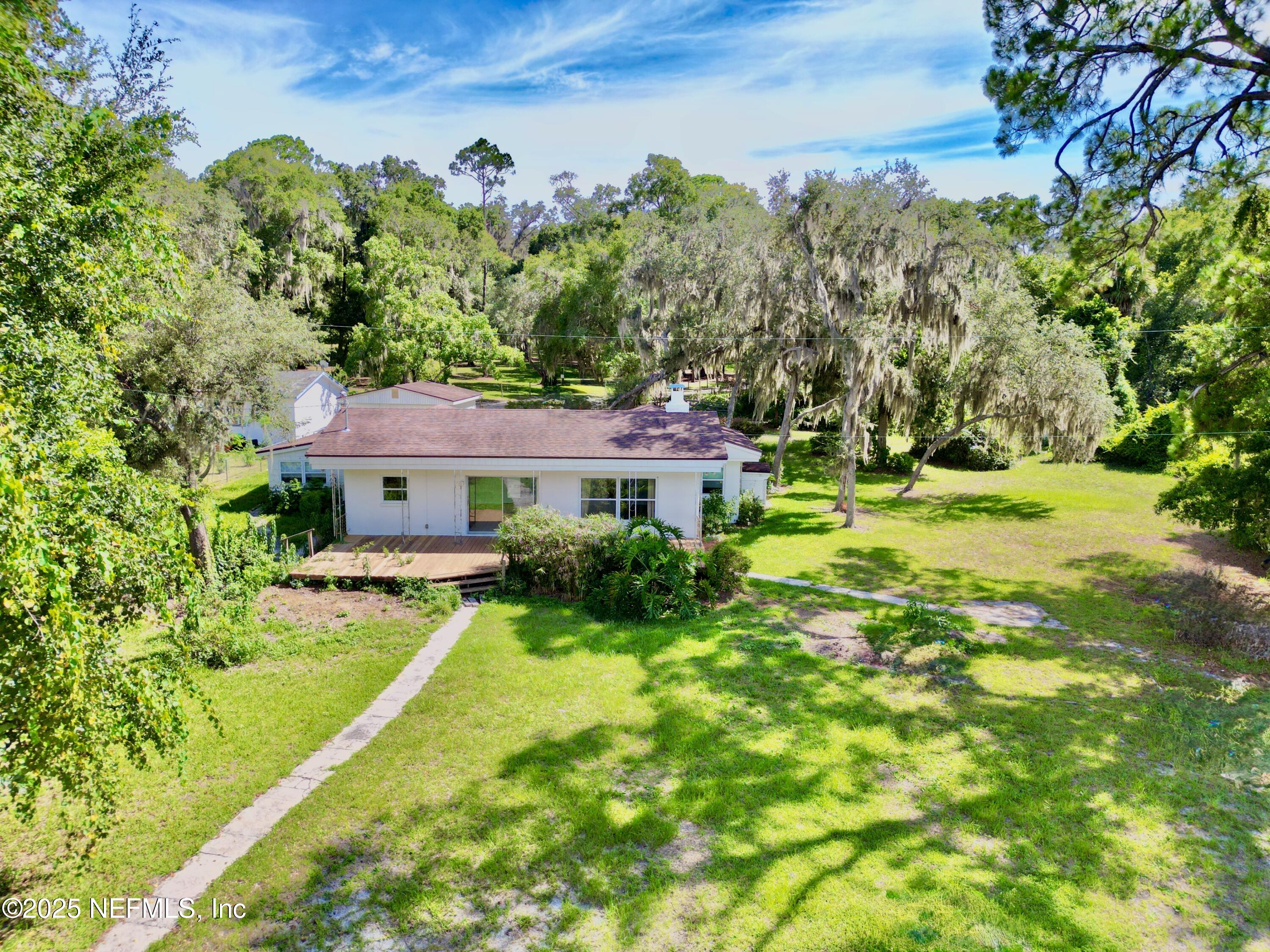 145 Depot Road Hawthorne, FL 32640 - Photo 54 of 73 a view of a house with a big yard potted plants and large tree