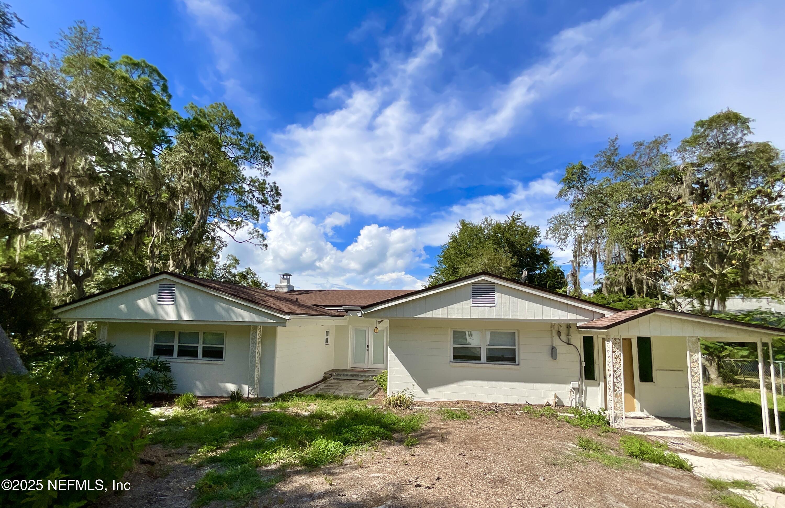 145 Depot Road Hawthorne, FL 32640 - Photo 6 of 73 a front view of a house with a yard and garage