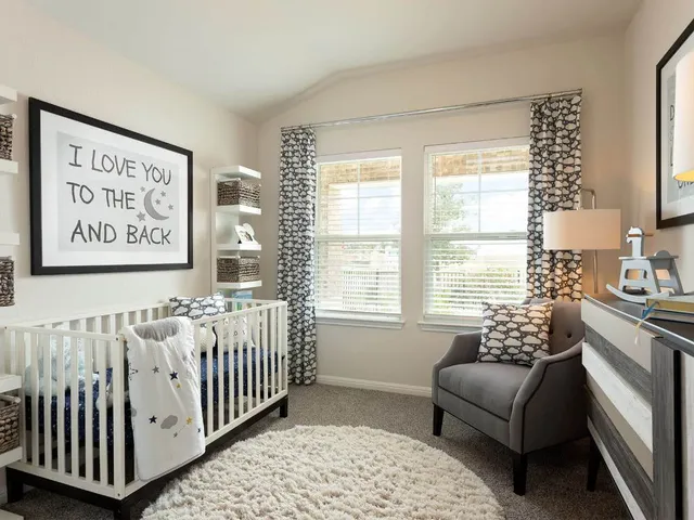 a bedroom with furniture and a large window