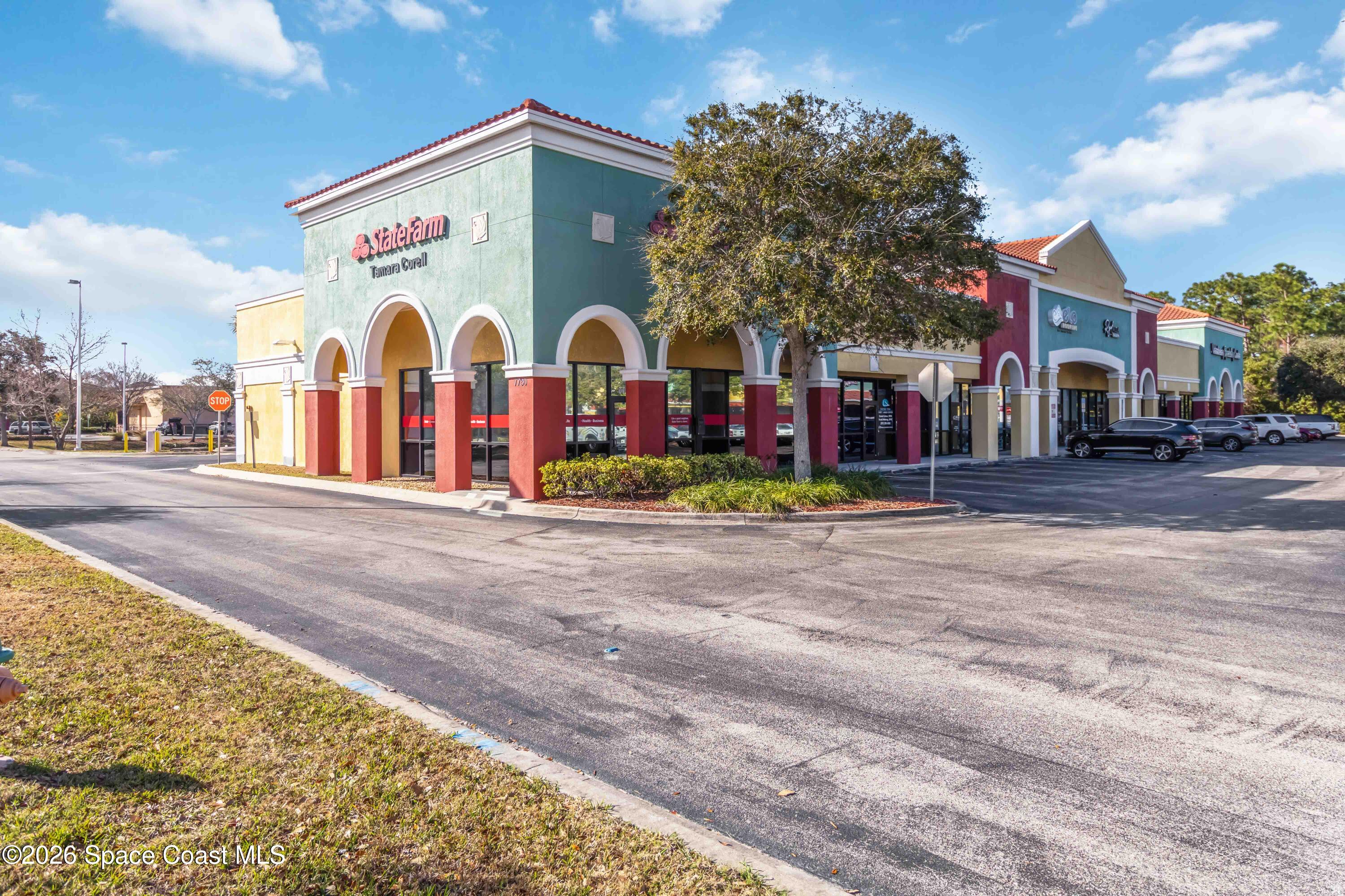7730 North Wickham Road, Unit 101 Melbourne, FL 32940 - Photo 1 of 48 a view of a building with a yard and plants