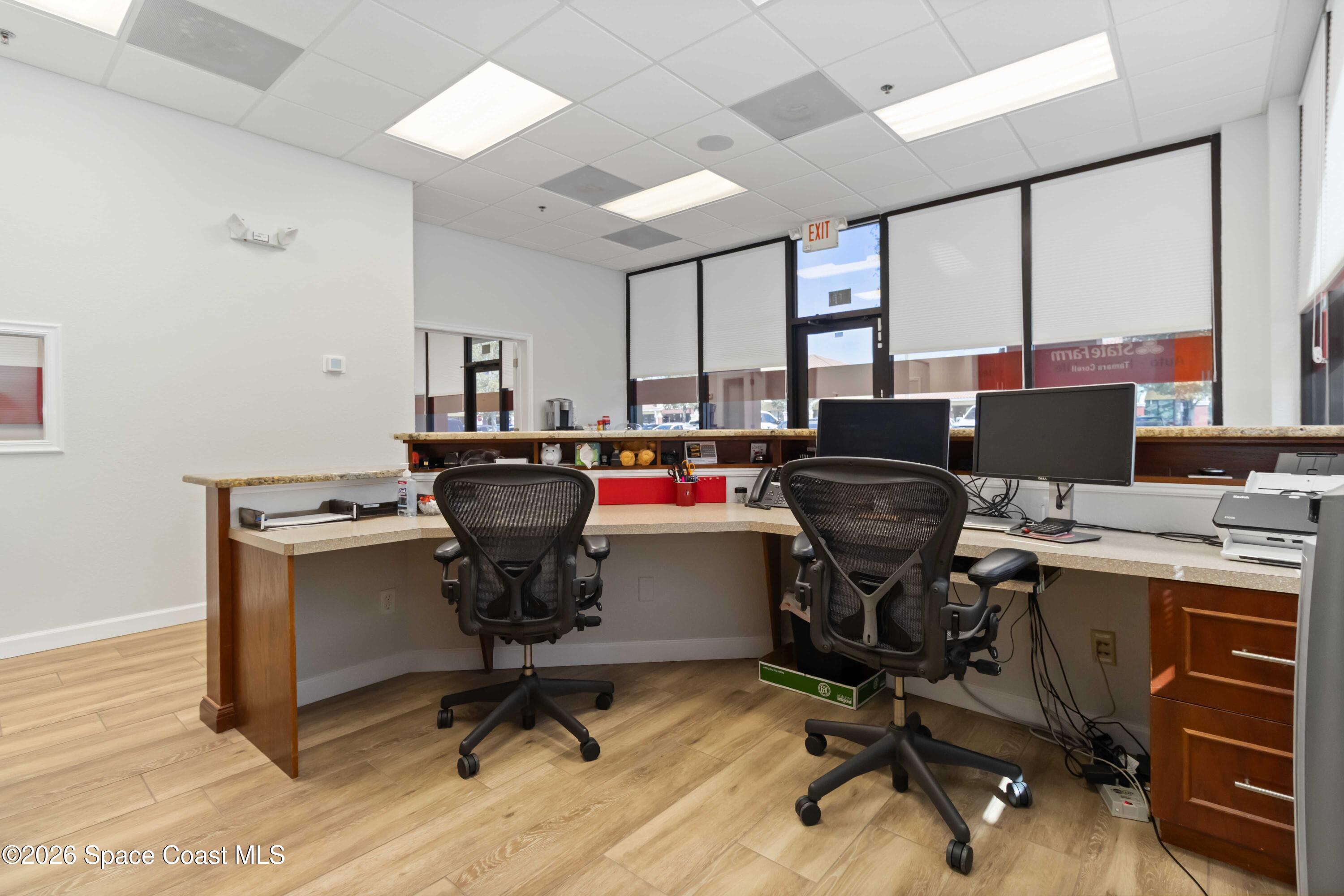 7730 North Wickham Road, Unit 101 Melbourne, FL 32940 - Photo 12 of 48 a view of a workspace with furniture and a window