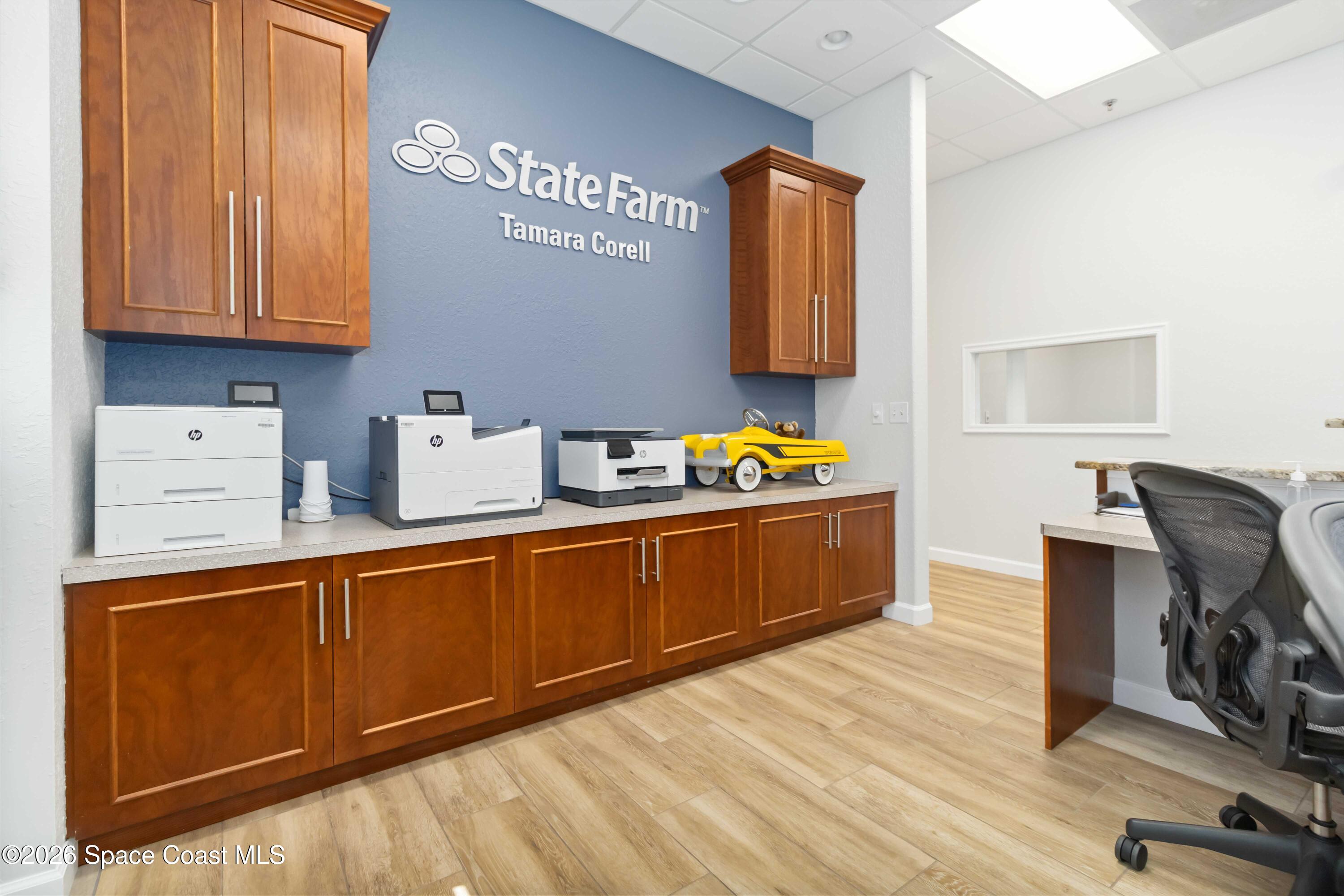 7730 North Wickham Road, Unit 101 Melbourne, FL 32940 - Photo 13 of 48 a kitchen with stainless steel appliances granite countertop a sink wooden cabinets and a granite counter tops