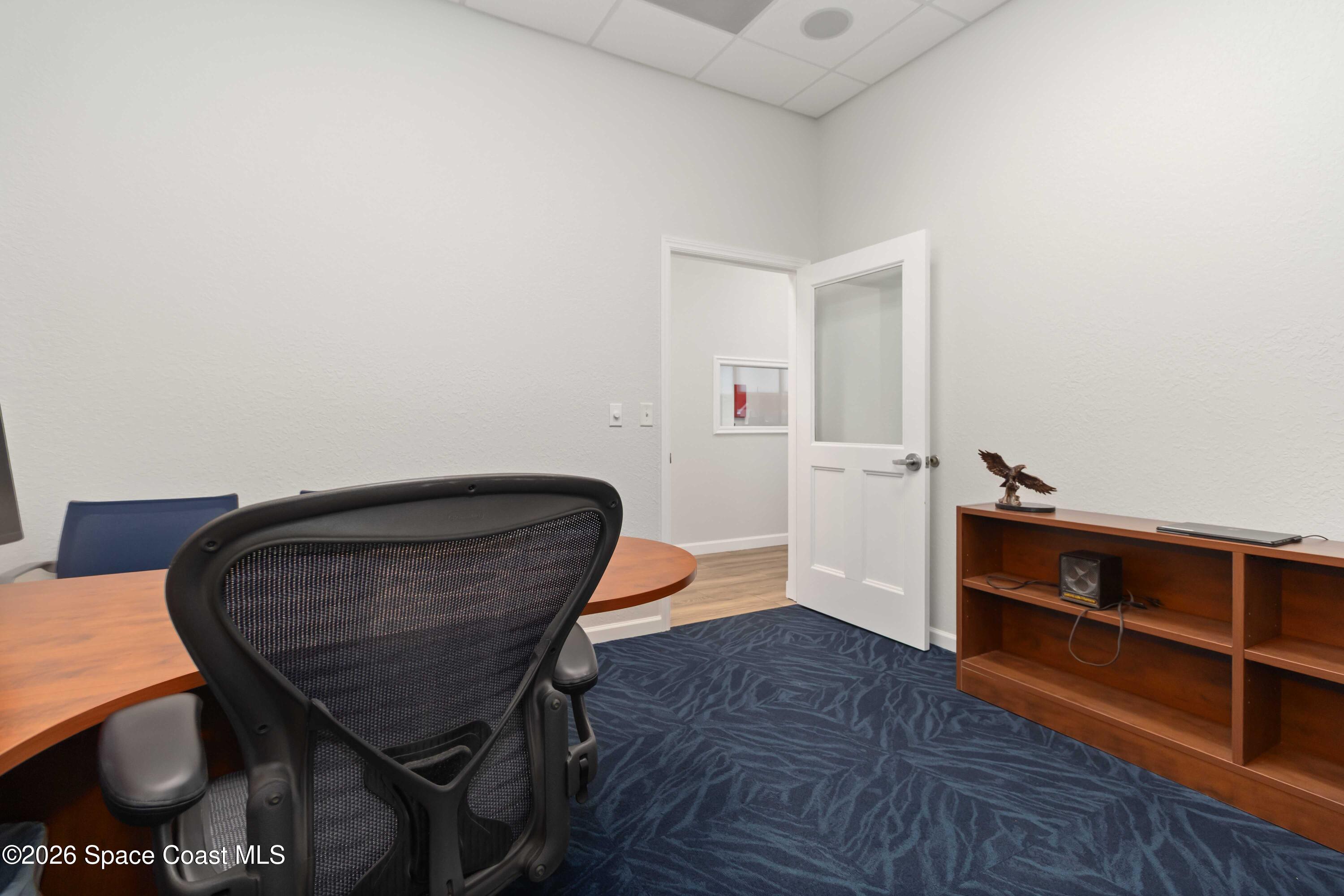 7730 North Wickham Road, Unit 101 Melbourne, FL 32940 - Photo 20 of 48 a living room with furniture and a chair