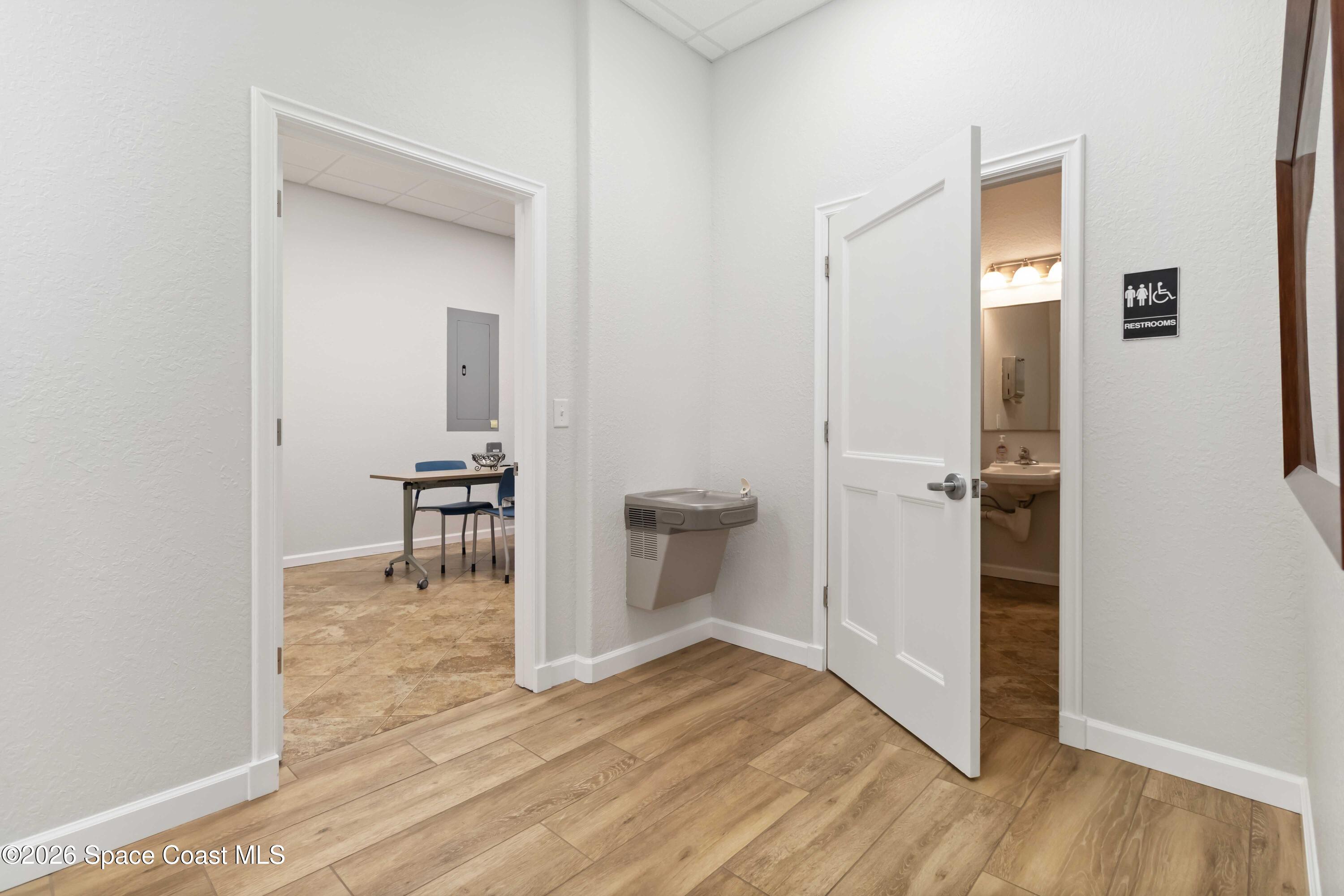 7730 North Wickham Road, Unit 101 Melbourne, FL 32940 - Photo 32 of 48 a view of a livingroom with wooden floor and a bathroom