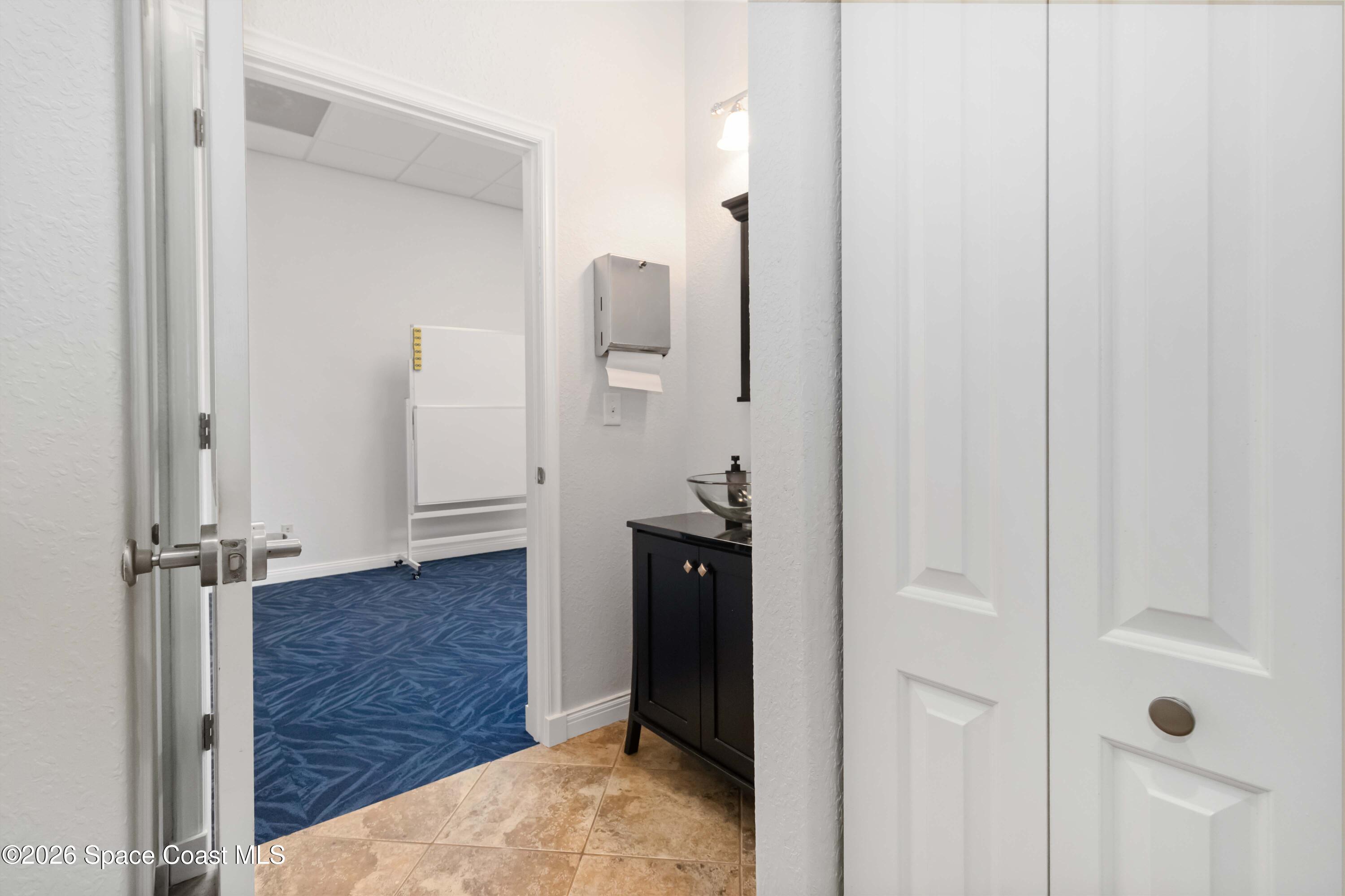 7730 North Wickham Road, Unit 101 Melbourne, FL 32940 - Photo 42 of 48 a view of a hallway with wooden floor