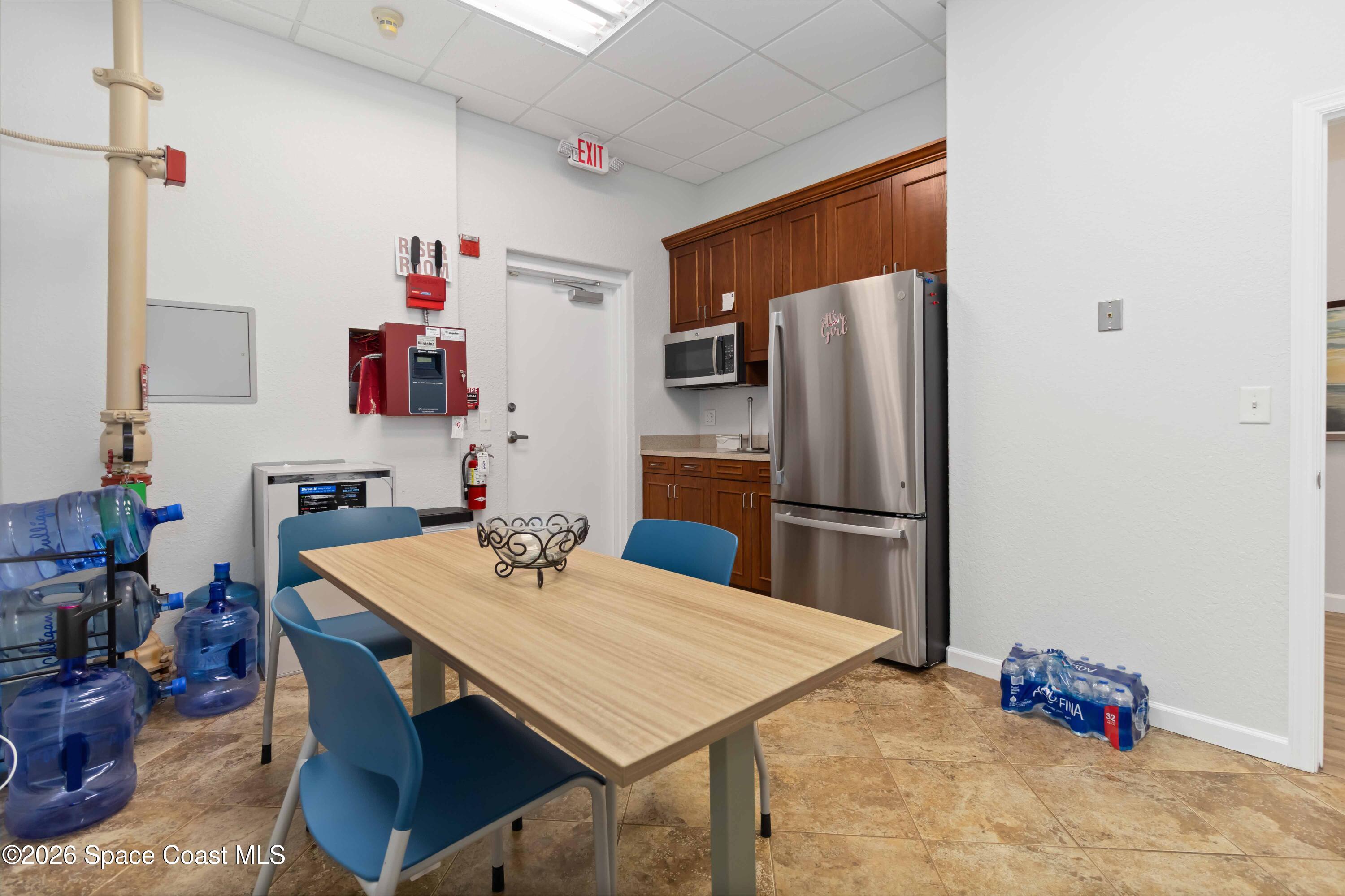 7730 North Wickham Road, Unit 101 Melbourne, FL 32940 - Photo 45 of 48 a kitchen with stainless steel appliances a refrigerator and a sink