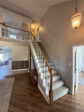 a view of entryway and hall with wooden floor