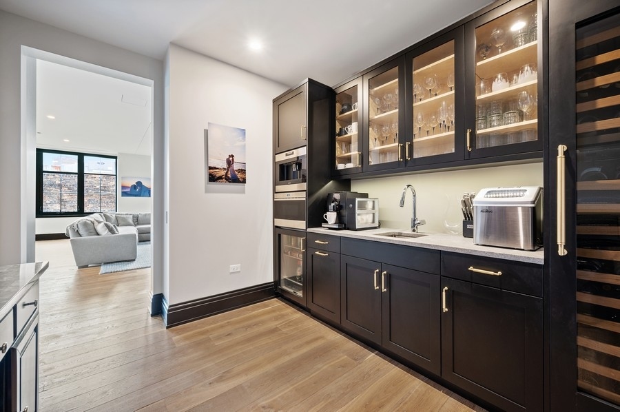 1109 West Washington Boulevard, Unit 4D Chicago, IL 60607 - Photo 11 of 31 a kitchen with a sink and wooden cabinets