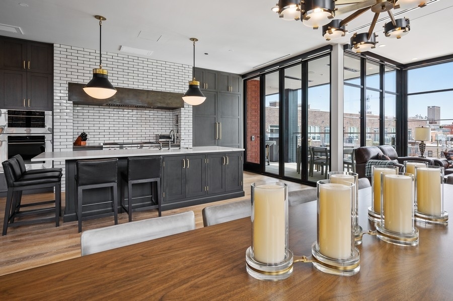 1109 West Washington Boulevard, Unit 4D Chicago, IL 60607 - Photo 14 of 31 a kitchen with stainless steel appliances granite countertop a stove and a wooden floors