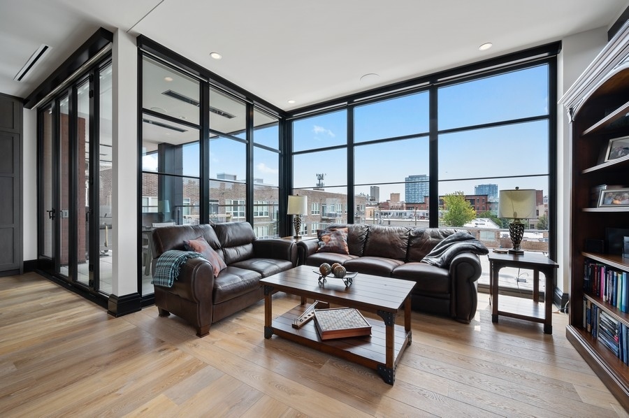 1109 West Washington Boulevard, Unit 4D Chicago, IL 60607 - Photo 15 of 31 a living room with furniture two large windows and a floor to ceiling window