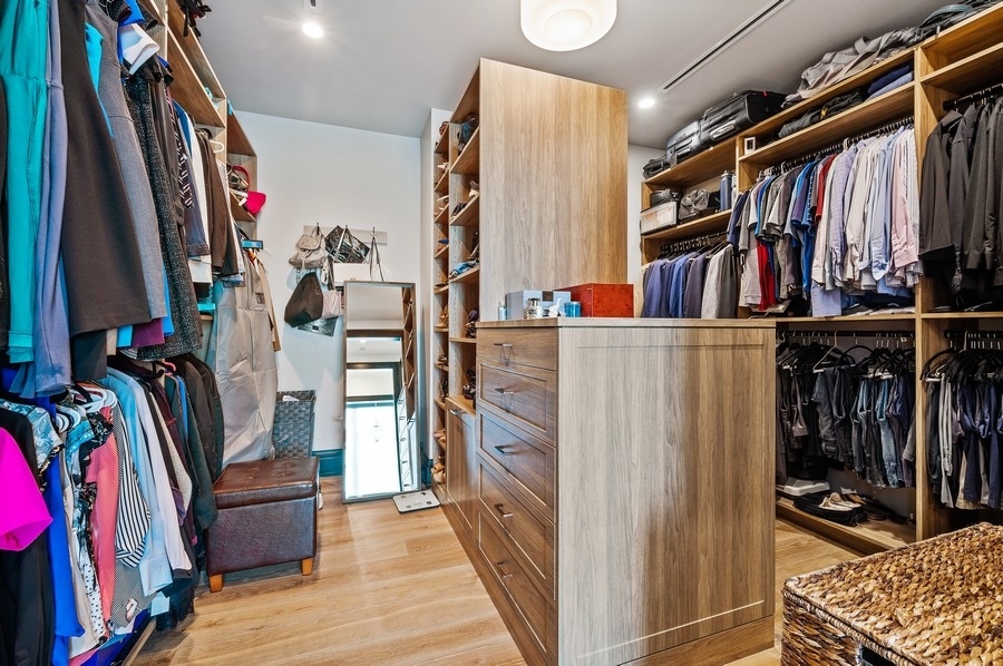 1109 West Washington Boulevard, Unit 4D Chicago, IL 60607 - Photo 21 of 31 a view of walk in closet with clothes and shoes