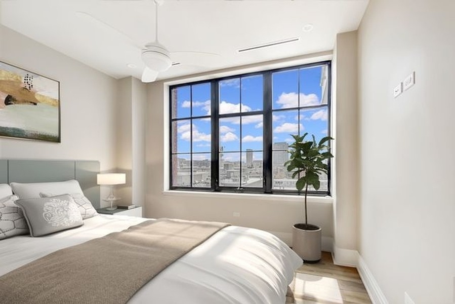 1109 West Washington Boulevard, Unit 4D Chicago, IL 60607 - Photo 23 of 31 a bedroom with a large bed and a window