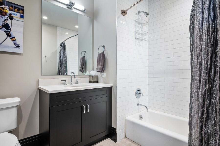 1109 West Washington Boulevard, Unit 4D Chicago, IL 60607 - Photo 24 of 31 a bathroom with a sink toilet tub and shower