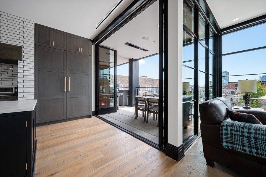 1109 West Washington Boulevard, Unit 4D Chicago, IL 60607 - Photo 28 of 31 a bedroom with furniture and large windows