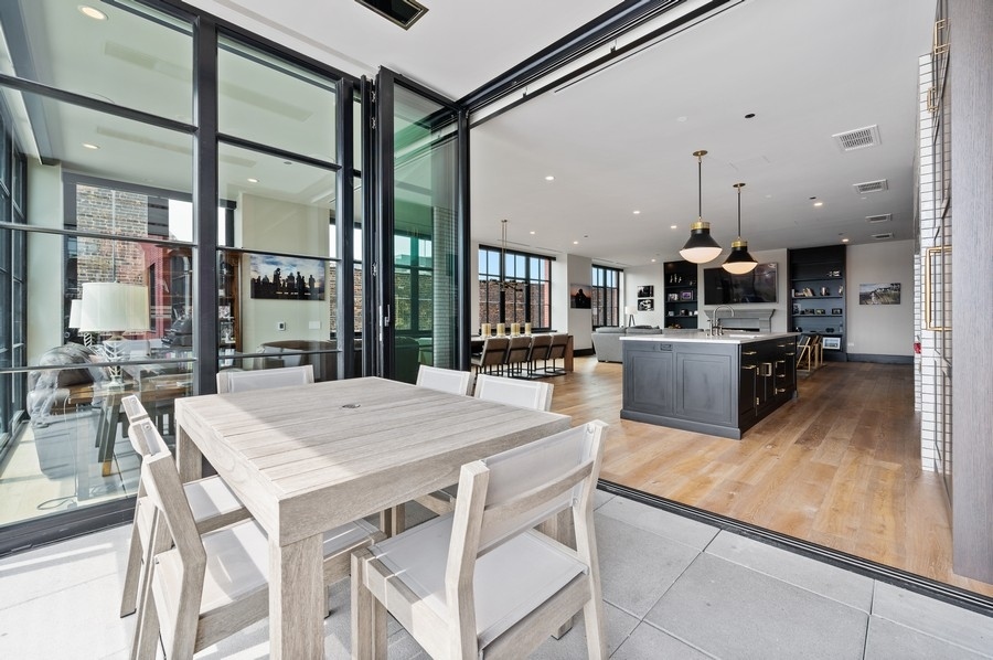 1109 West Washington Boulevard, Unit 4D Chicago, IL 60607 - Photo 29 of 31 a large kitchen with a table and chairs