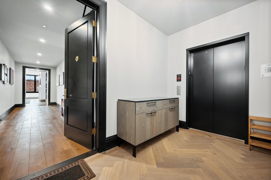 1109 West Washington Boulevard, Unit 4D Chicago, IL 60607 - Photo 3 of 31 a view of a hallway with wooden floor