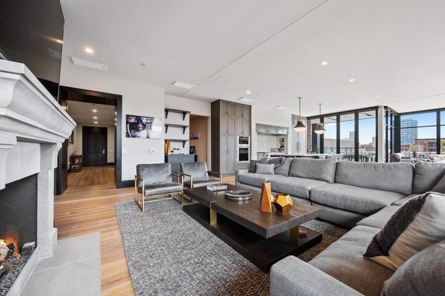 1109 West Washington Boulevard, Unit 4D Chicago, IL 60607 - Photo 6 of 31 a living room with furniture kitchen view and a fireplace