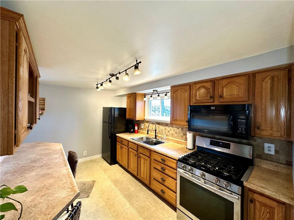 118 Foster Road Beaver Falls, PA 15010 - Photo 21 of 41 a kitchen with stainless steel appliances kitchen island granite countertop a stove and a sink