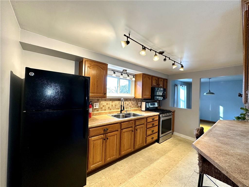 118 Foster Road Beaver Falls, PA 15010 - Photo 22 of 41 a kitchen with a sink stainless steel appliances and counter space