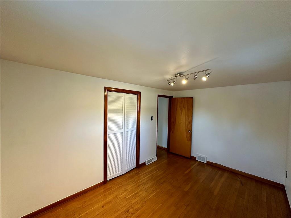 118 Foster Road Beaver Falls, PA 15010 - Photo 29 of 41 an empty room with wooden floor and windows