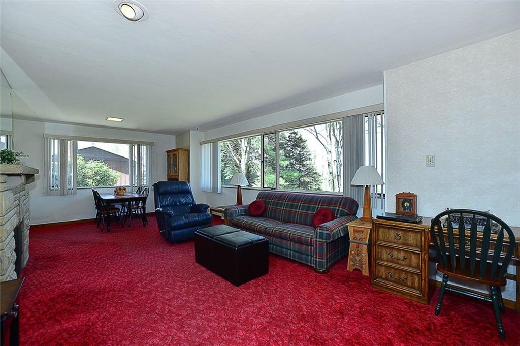 280 Pine Road Pittsburgh, PA 15237 - Photo 5 of 14 Huge family room with stone fireplace, hardwoods under carpet, 8 ft ceiling and wall of windows.