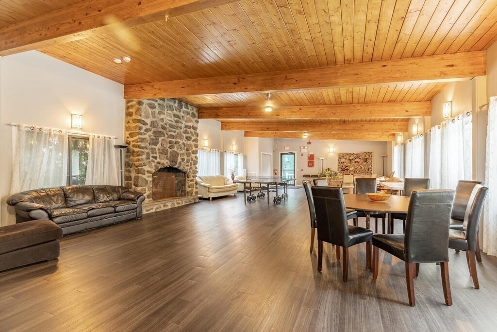 55 Broadlawn Park, Unit S2 Boston, MA 02467 - Photo 11 of 14 a view of a dining room with furniture window and wooden floor