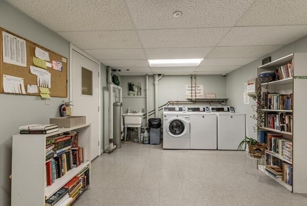 55 Broadlawn Park, Unit S2 Boston, MA 02467 - Photo 12 of 14 a utility room with cabinets dryer and washer