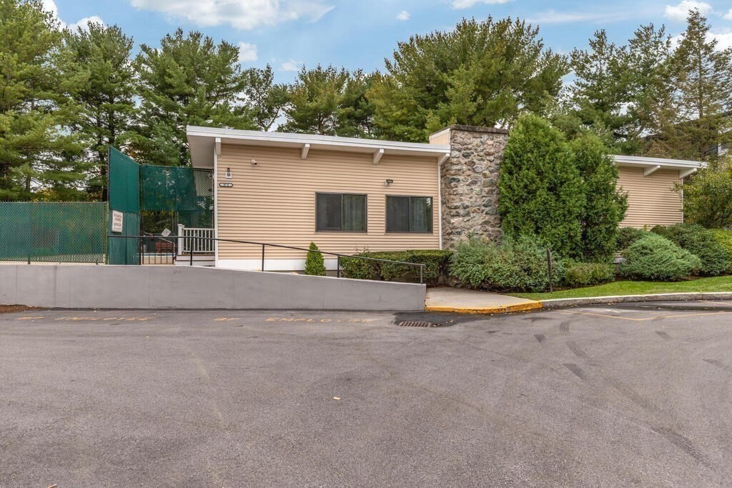 55 Broadlawn Park, Unit S2 Boston, MA 02467 - Photo 13 of 14 a view of a house with a yard and a large tree