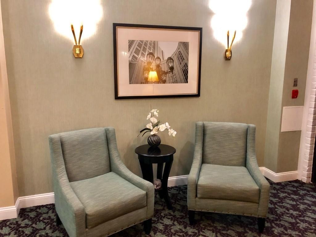 55 Broadlawn Park, Unit S2 Boston, MA 02467 - Photo 2 of 14 a living room with furniture and wall painting