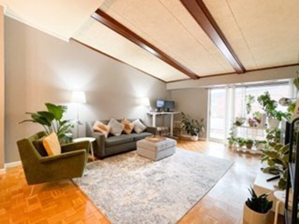 55 Broadlawn Park, Unit S2 Boston, MA 02467 - Photo 3 of 14 a living room with furniture and a large window