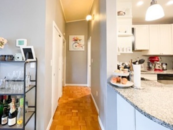 55 Broadlawn Park, Unit S2 Boston, MA 02467 - Photo 7 of 14 a en suite bathroom with a granite countertop sink and a mirror