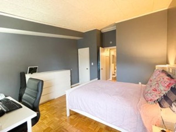 55 Broadlawn Park, Unit S2 Boston, MA 02467 - Photo 9 of 14 a bedroom with a bed and a couch