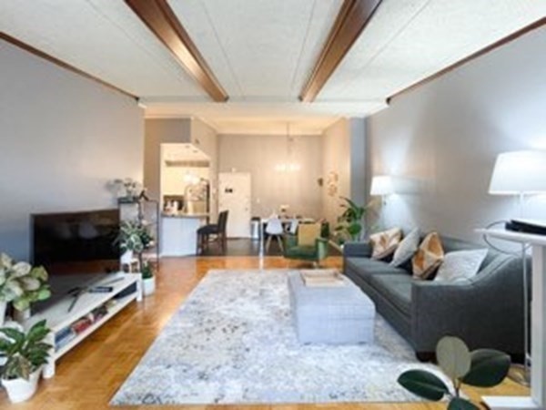 55 Broadlawn Park, Unit S2 Boston, MA 02467 - Photo 10 of 14 a living room with furniture and a flat screen tv