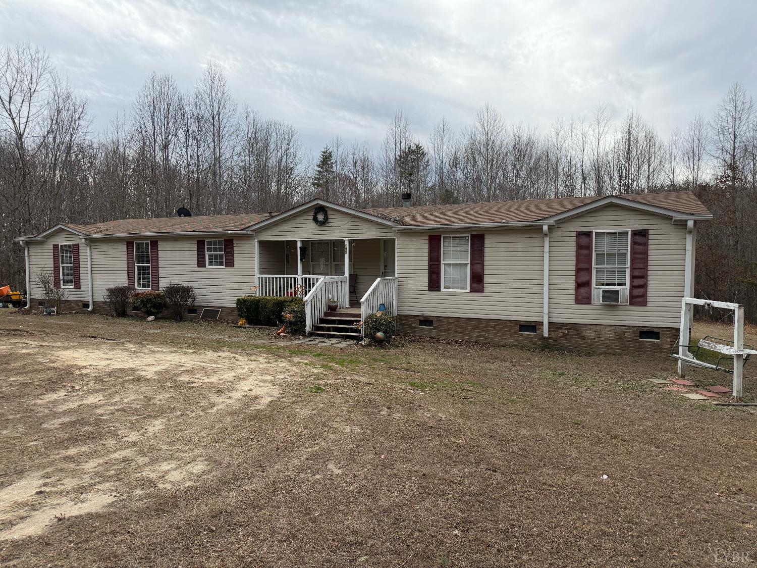a view of a house with a yard and sitting area