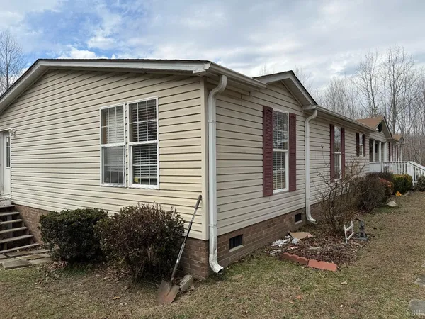 a view of a house with a yard and sitting area