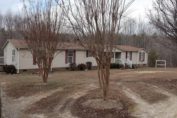 a front view of a house with a tree